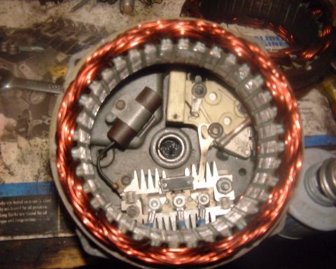 1985 Ford F-150 - Close-up view of an alternator's internal components, including copper windings and electrical parts.