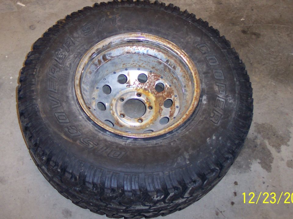 Tire and rusty rim on a concrete floor