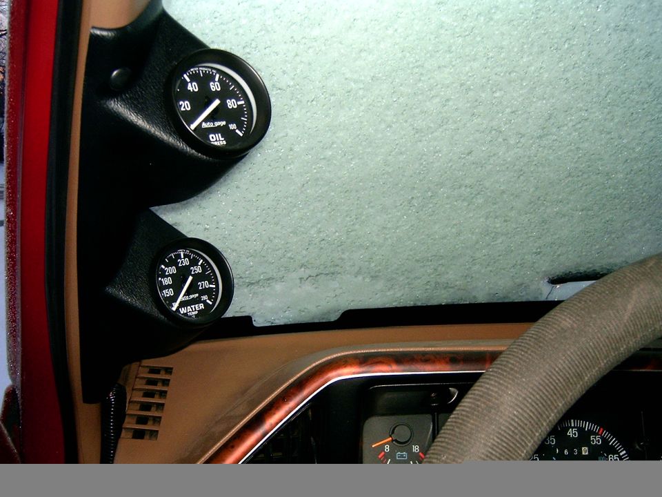 A-pillar pod with Auto Gage oil pressure and water temp gauges on tan dash, frosted windshield