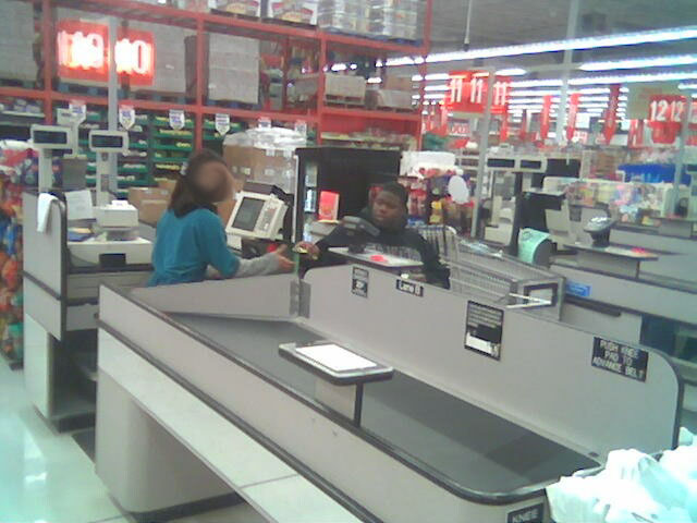 Grocery store checkout lanes with cashiers and customers