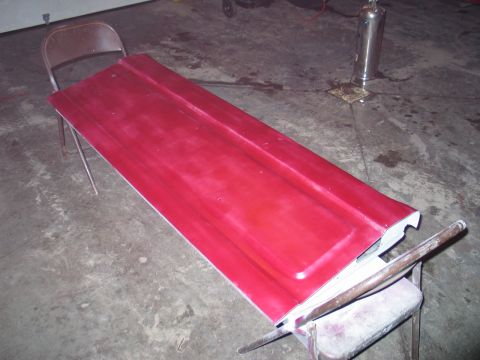1995 Ford Bronco - A red tailgate is propped up on sawhorses, likely awaiting repair or painting.