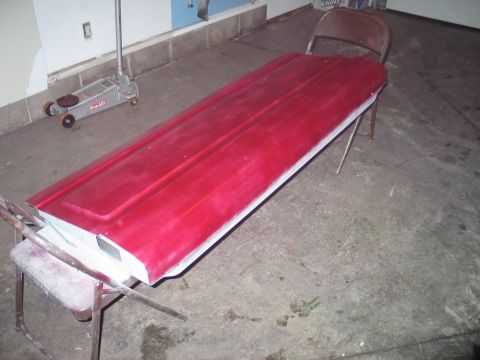 1995 Ford Bronco - A red car door is being used as a makeshift table, supported by chairs.