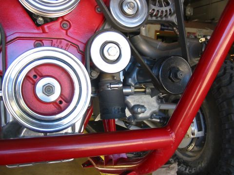 1993 Ford Taurus - Detail of engine components including pulleys, belts, and hoses, with a red tubular frame in the foreground.