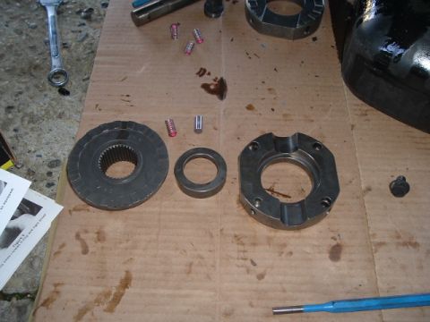 1989 Ford Bronco - Various differential components and tools are arranged on a piece of cardboard, suggesting a repair or installation process.