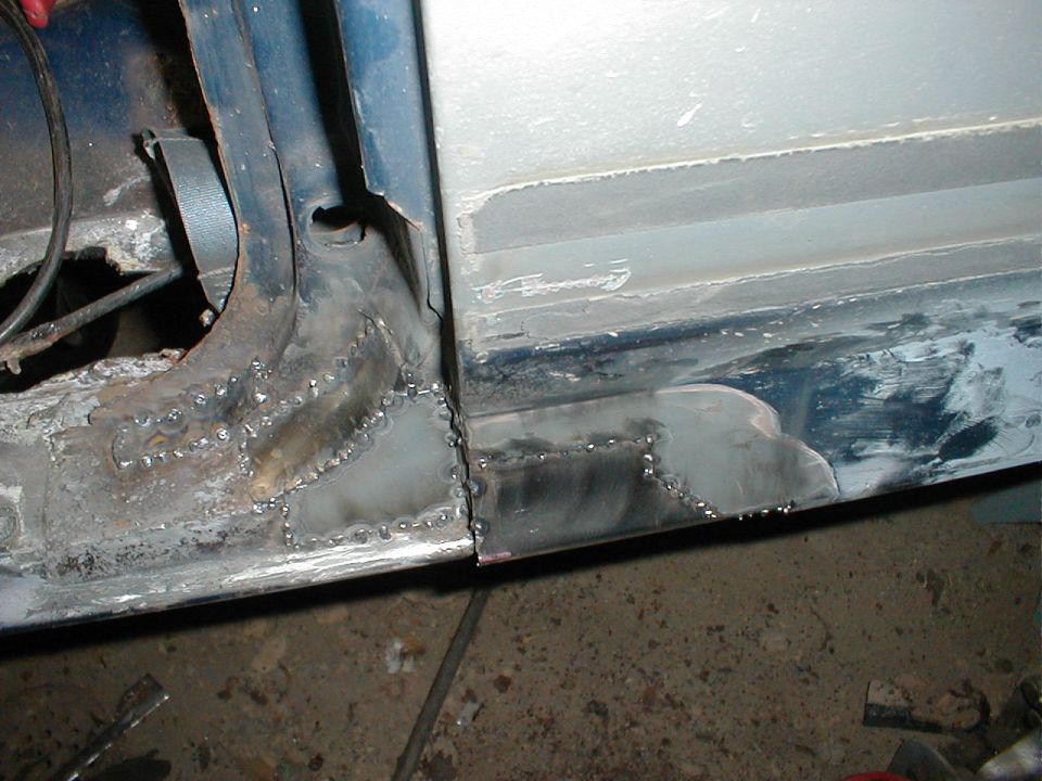 Fresh weld repair joining sheet metal at a vehicle rocker and door pillar in a garage