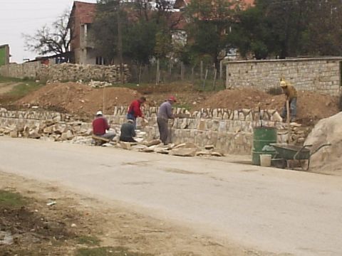 1996 Ford Bronco - Masons building a new wall. The ones sitting are hand shaping the pieces of rock with hammers for the perfect fit.