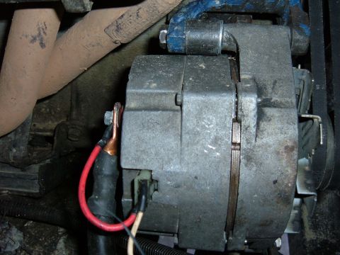 1985 Ford F-150 - Alternator and exhaust manifold detail, likely from an older vehicle.