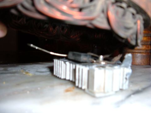 1985 Ford F-150 - A close-up view of an alternator's voltage regulator, with the Supermotors.net logo visible in the lower right corner.