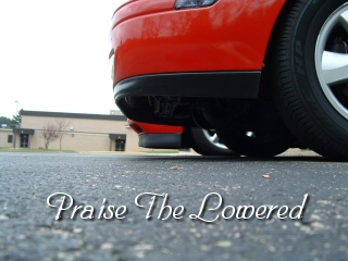 1994 Volkswagen Jetta - A red car's rear bumper and exhaust are visible, with a graphic overlay reading 'Praise The Lowered'.