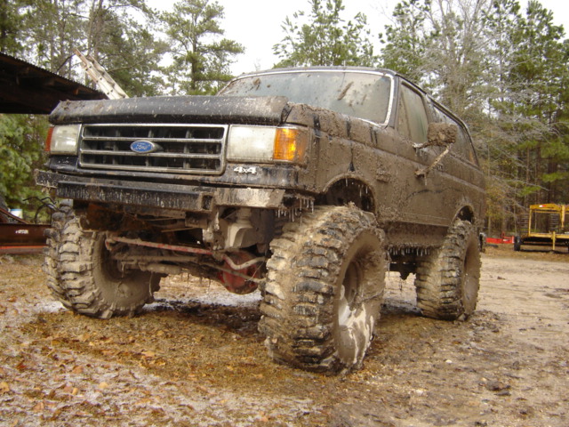 muddy Ford Bronco with big tires, looks like it's been off-roading