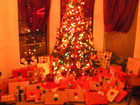 1978 Ford Bronco - A festive scene with a decorated Christmas tree and numerous presents piled around its base.