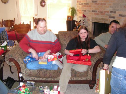 1978 Ford Bronco - People are opening gifts on a couch in a living room decorated for Christmas.