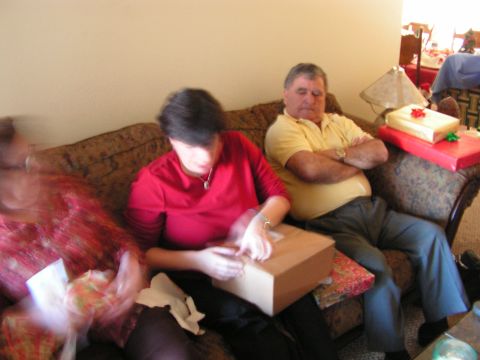 1978 Ford Bronco - Three people are gathered on a couch, opening Christmas presents.
