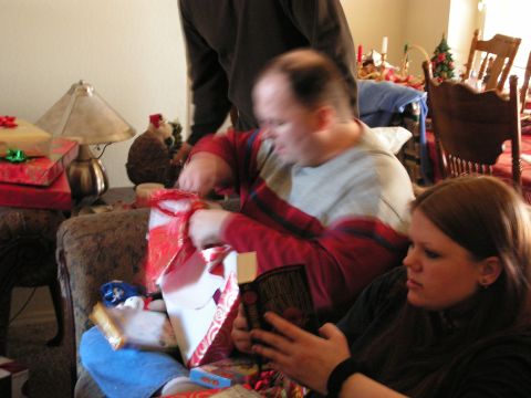 1978 Ford Bronco - A group of people are gathered around opening presents on Christmas.