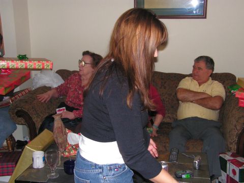 1978 Ford Bronco - A group of people are in a living room, with Christmas presents scattered around, suggesting a holiday gathering.