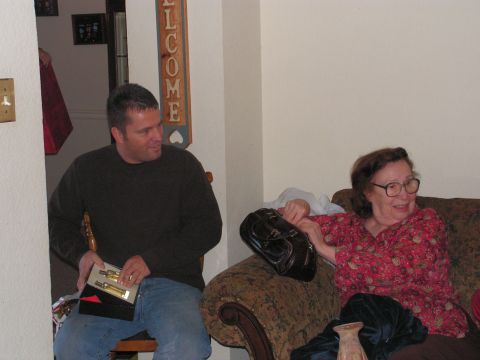 1978 Ford Bronco - A man presents a gift to a woman while sitting in a living room.