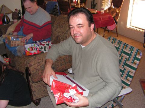 1978 Ford Bronco - Two men and a woman are gathered in a living room, unwrapping presents on Christmas.