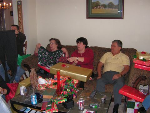 1978 Ford Bronco - Family members open presents during a Christmas celebration.