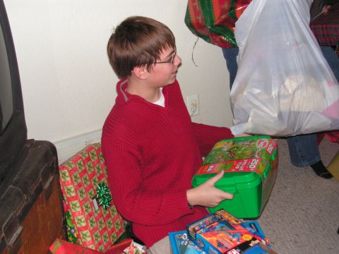 1978 Ford Bronco - A young boy receives gifts during a holiday celebration, with several presents visible around him.