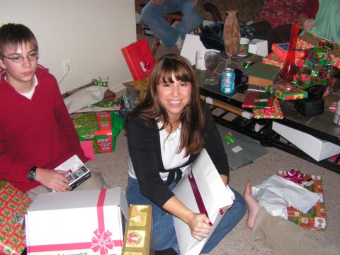 1978 Ford Bronco - A group of people are gathered indoors, surrounded by Christmas gifts and decorations.