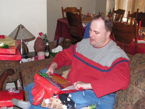 1978 Ford Bronco - A man unwraps presents on Christmas, with the Supermotors.net logo visible in the lower right corner.