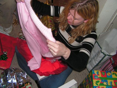 1978 Ford Bronco - Woman opening a pink sweater from a gift box, surrounded by Christmas presents.