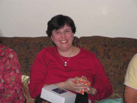 1978 Ford Bronco - A woman smiles while holding a gift, seated on a patterned couch.