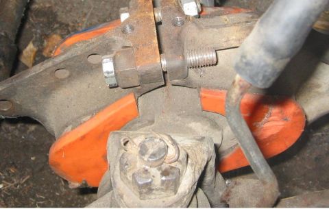 1985 Ford Bronco - Automotive suspension part with orange bushing and metal components.