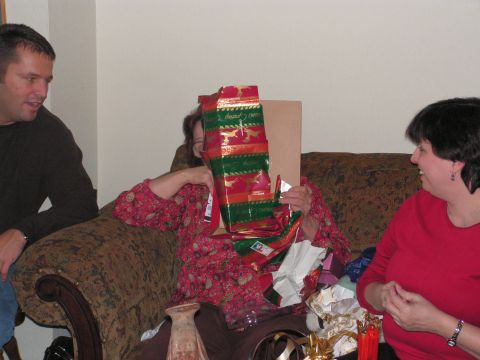 1978 Ford Bronco - Family members opening presents during a holiday gathering.