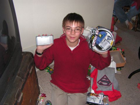 1978 Ford Bronco - A boy proudly displays his new gifts, surrounded by the festive atmosphere of gift-giving.