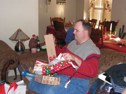 1978 Ford Bronco - A man unwraps gifts on Christmas morning, surrounded by presents and holiday decorations.