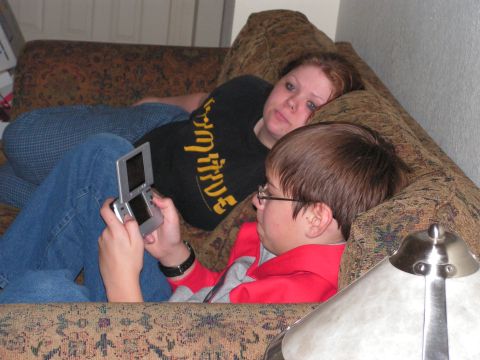 1978 Ford Bronco - A young person plays a video game while another person watches, both lounging on a patterned sofa.