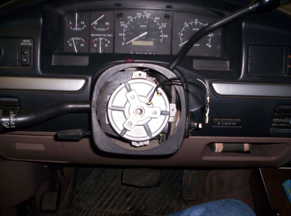 Dash with steering wheel removed showing exposed steering column hub and gauge cluster