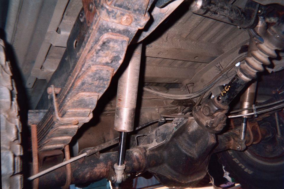 Undercarriage showing rear leaf spring, shock absorber, differential and driveshaft