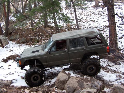1985 Ford Bronco - This modified Jeep Cherokee XJ navigates a rocky, snow-dusted trail.