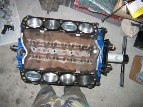 1992 Ford Bronco - A V8 engine block painted blue, viewed from above with the cylinder heads removed, showing eight bare cylinder bores and the freshly machin…