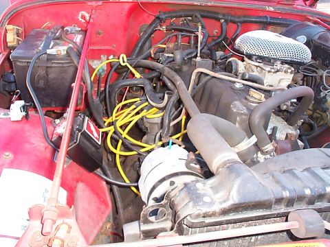 1989 Jeep YJ - Close-up view of the engine compartment in a red Jeep.