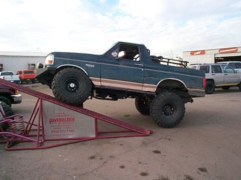 1994 Ford Bronco - A modified Ford Bronco is positioned on a ramp, its off-road capabilities.