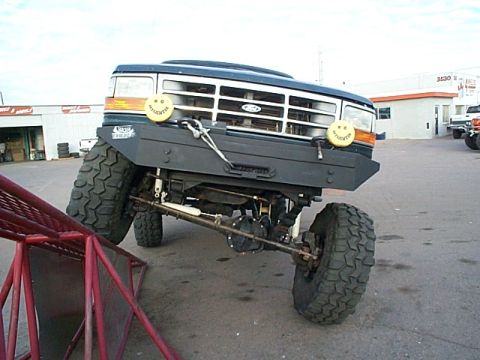 1994 Ford Bronco - This 1994 Ford Bronco features a heavy-duty custom bumper and oversized tires, giving it an aggressive stance.