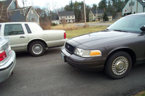 2001 Ford Crown Victoria - A 2001 Ford Crown Victoria is parked next to another vehicle.
