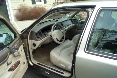 2001 Ford Crown Victoria - Interior view of a sedan, likely a Lincoln Town Car, with tan leather seats and wood trim.