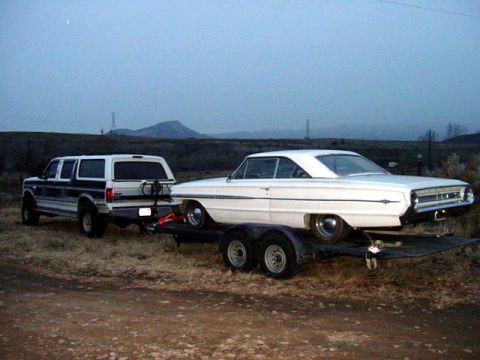 1964 Ford Galaxie - A 1964 Ford Galaxie is transported on a trailer pulled by a Ford Bronco.