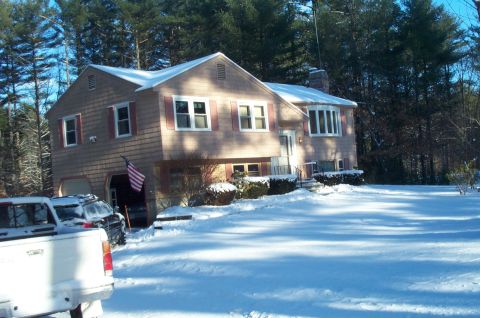 2001 Ford Crown Victoria - A house and driveway covered in snow with two vehicles visible.