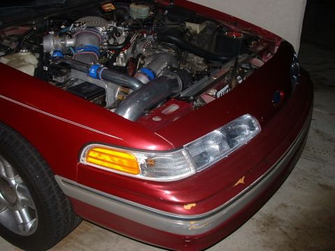 1992 Ford Crown Victoria - Engine bay of a 1992 Ford Crown Victoria showing custom turbocharger setup.