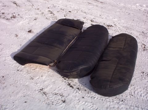 1991 Ford LTD Crown Victoria - Three black car seats are visible on the ground in the snow.
