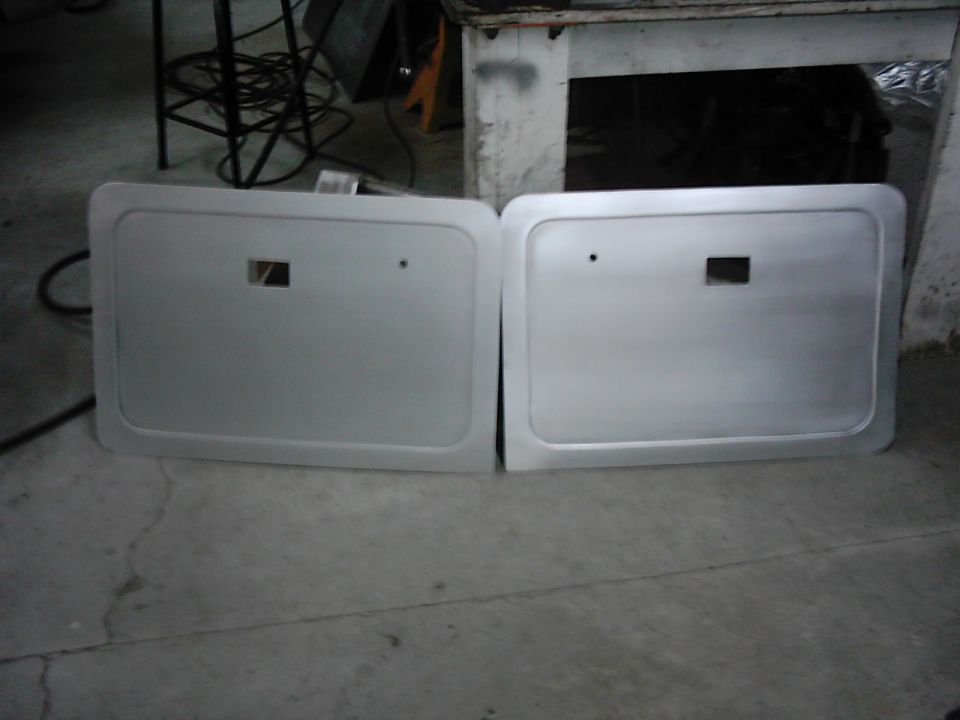 Two silver door panels with square cutouts