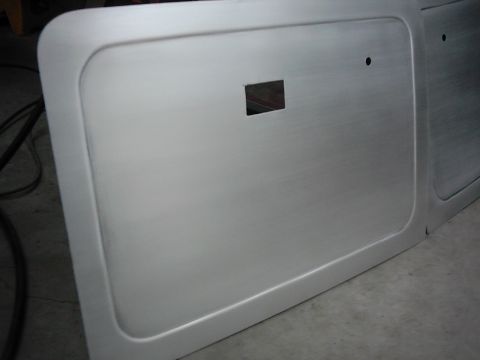 1978 Ford Bronco - Brushed aluminum door panel part with a square cutout visible.