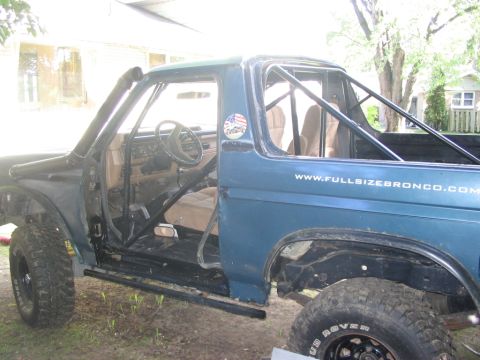 1986 Ford Bronco - This modified Ford Bronco features a prominent roll cage and snorkel, suggesting off-road use.