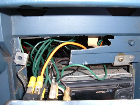 1985 Ford F-150 - Close-up view of the interior wiring and car stereo system in a 1985 Ford F-150.