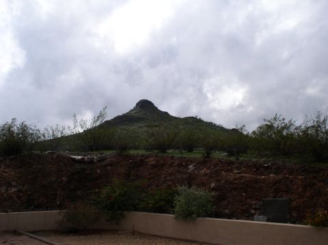 1990 Ford Bronco - A view of a mountain and surrounding arid landscape under a cloudy sky.